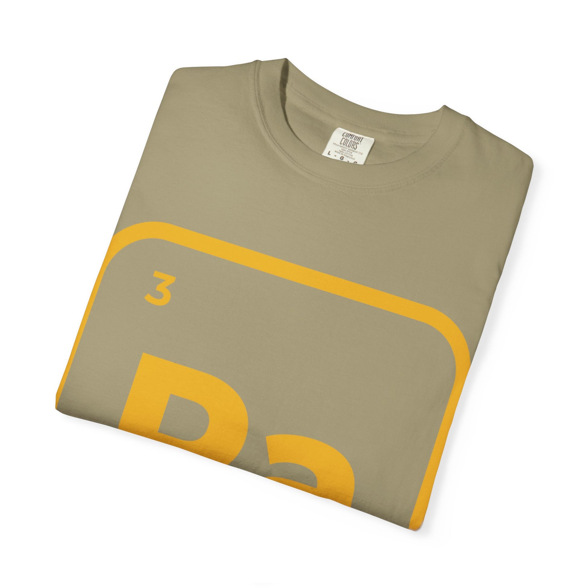 Folded khaki Ra Element T-Shirt with golden Kemetic symbol. Trendy cotton tee for summer festivals and music-themed outfits.