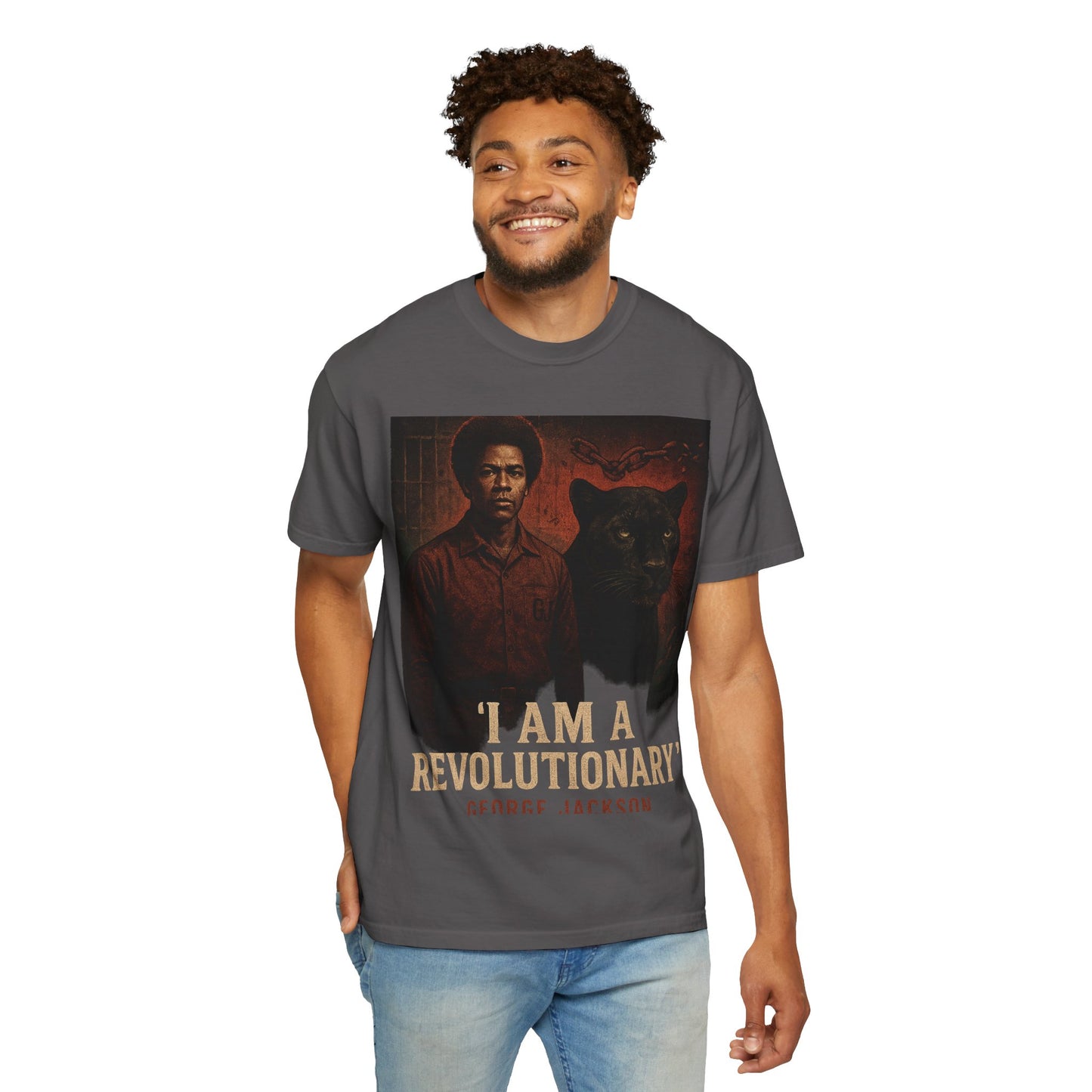 Model wearing charcoal George Jackson T-Shirt with activist-themed print and 'I Am A Revolutionary' slogan. Unisex fit, casual streetwear style.